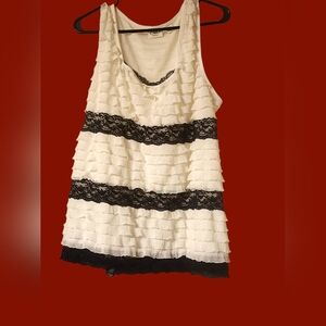 Sleeveless cute Cato blouse with ruffle layers.